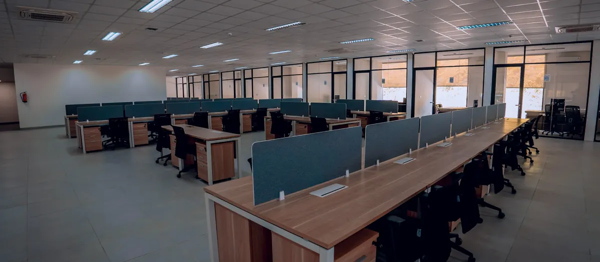 Rows of desks in a bright open-plan office